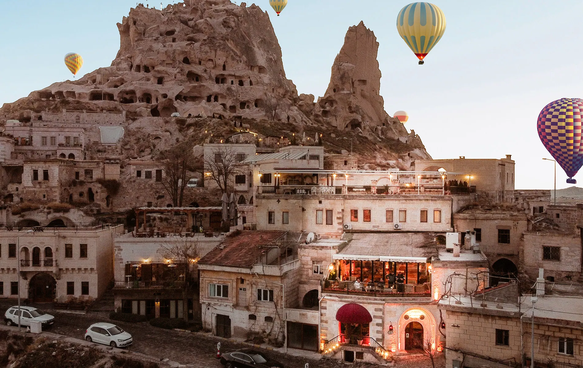 Stone hotel terrace in Uçhisar with hot air balloons